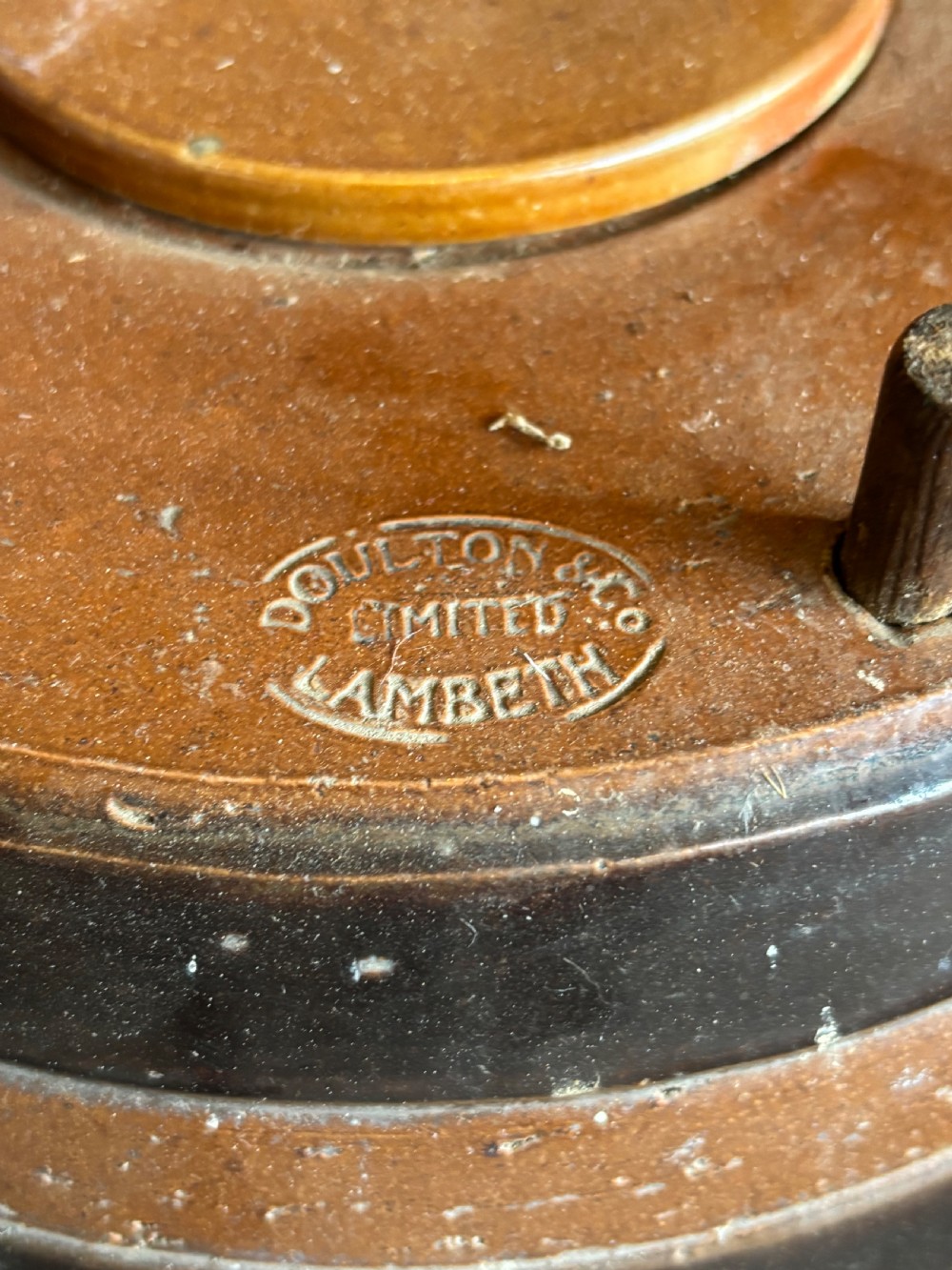 A Victorian Doulton Lambeth salt-glazed stoneware spirit cask featuring dark brown painted bands, a fitted wooden lid, and a wooden spigot tap at the base. View III