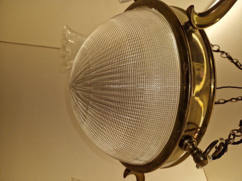 An Edwardian brass ceiling light fitting featuring three chain-suspended stiletto glass shades surrounding a central prismatic glass bowl. View V