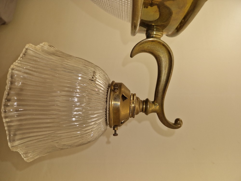 An Edwardian brass ceiling light fitting featuring three chain-suspended stiletto glass shades surrounding a central prismatic glass bowl. View VI