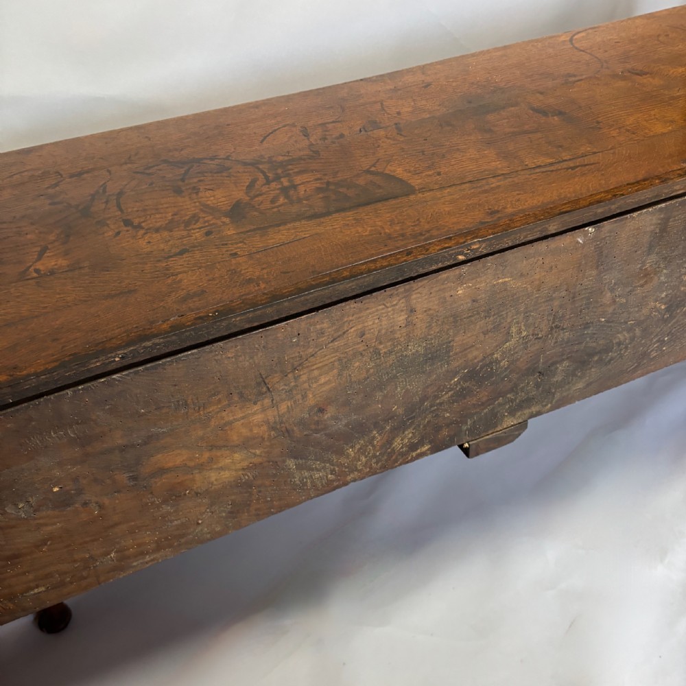 A George III period oak dresser base featuring three drawers with brass swan-neck handles and front cabriole legs. View III