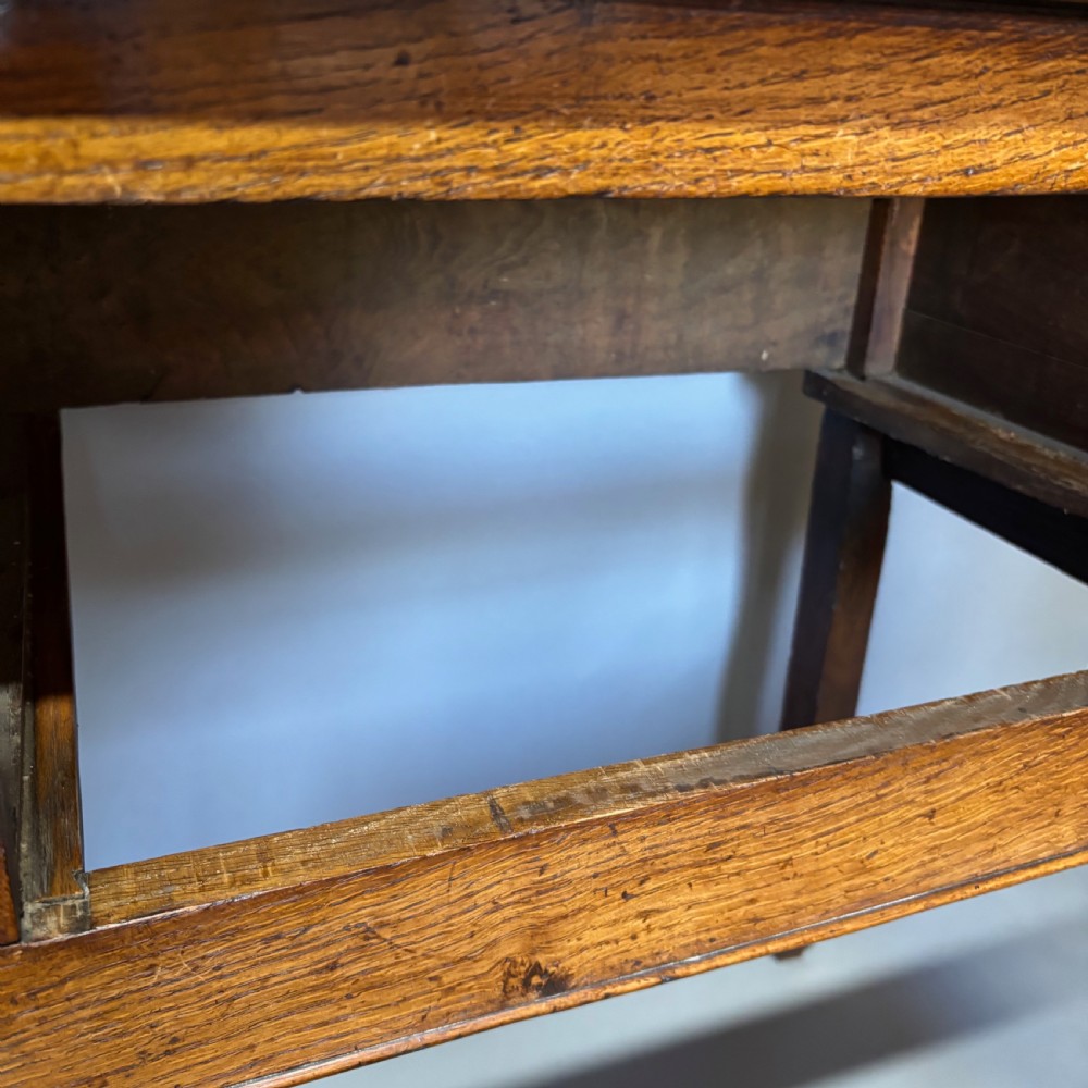 A George III period oak dresser base featuring three drawers with brass swan-neck handles and front cabriole legs. View XIV