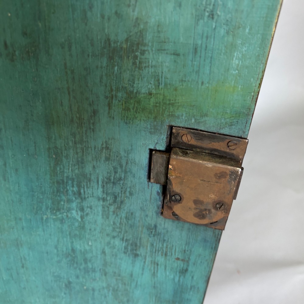 A Georgian bowfront mahogany corner cupboard featuring distinctive plum pudding grain, brass escutcheons, and visible brass H-hinges. View X