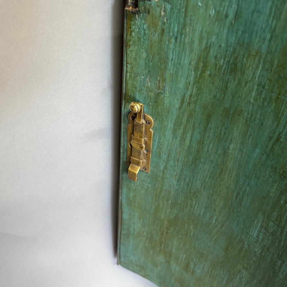 A Georgian bowfront mahogany corner cupboard featuring distinctive plum pudding grain, brass escutcheons, and visible brass H-hinges. View XII