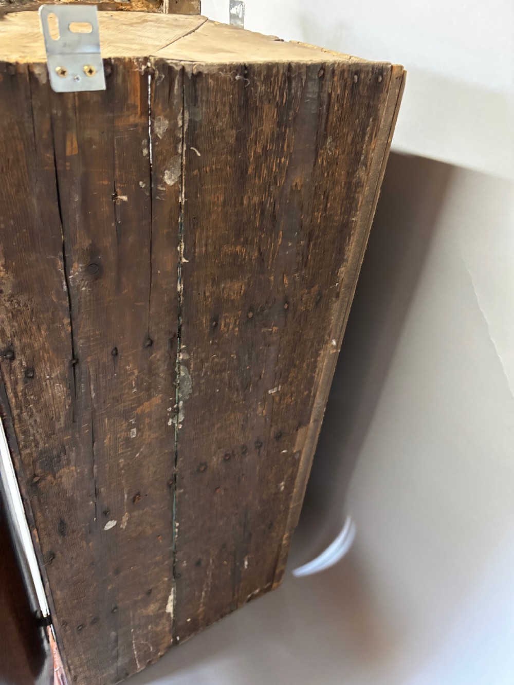 A Georgian bowfront mahogany corner cupboard featuring distinctive plum pudding grain, brass escutcheons, and visible brass H-hinges. View XV