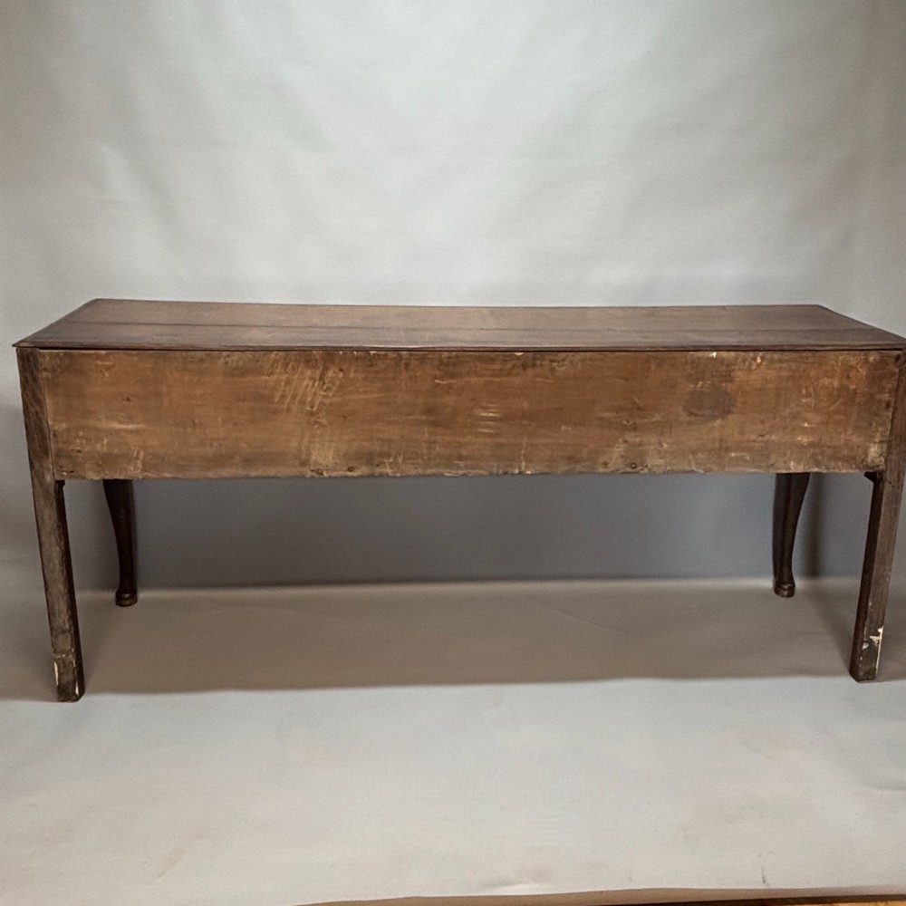 An eighteenth-century oak low dresser featuring three crossbanded drawers with brass swan-neck handles, elevated on four cabriole legs. View XII