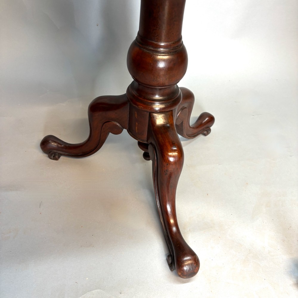 A Victorian dark mahogany shaving stand featuring an adjustable circular mirror, a round tier, a hinged compartment, turned support stem, and tripod cabriole legs. View VII