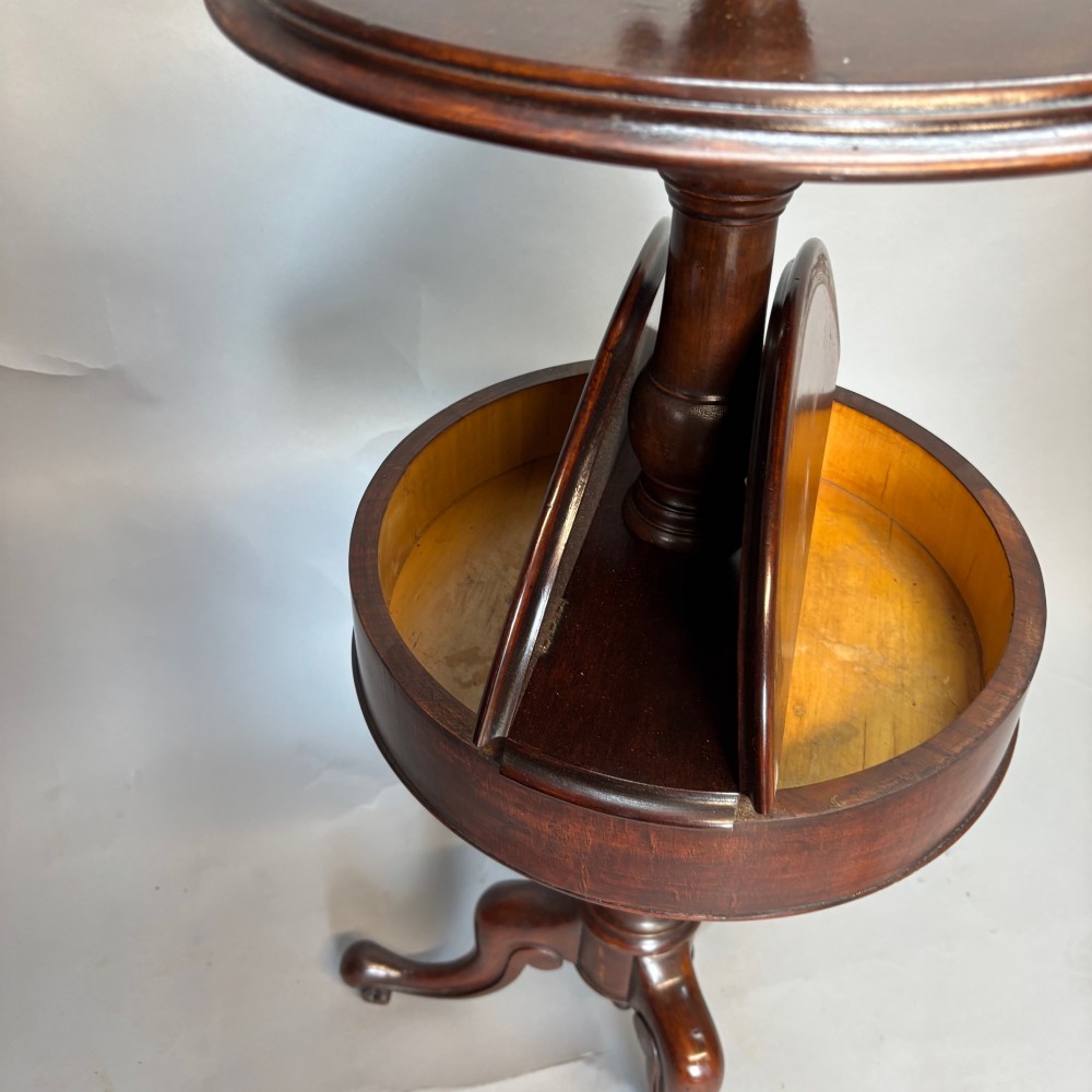 A Victorian dark mahogany shaving stand featuring an adjustable circular mirror, a round tier, a hinged compartment, turned support stem, and tripod cabriole legs. View VIII