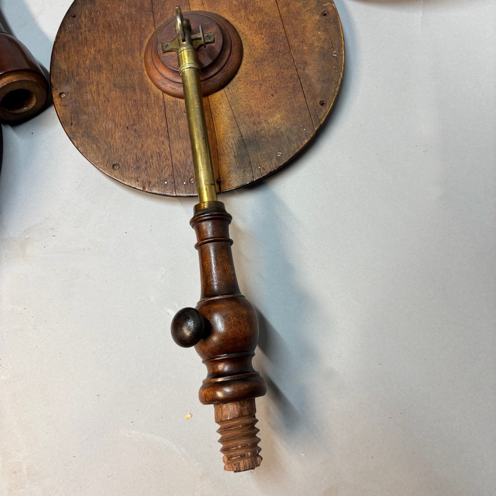 A Victorian dark mahogany shaving stand featuring an adjustable circular mirror, a round tier, a hinged compartment, turned support stem, and tripod cabriole legs. View IX