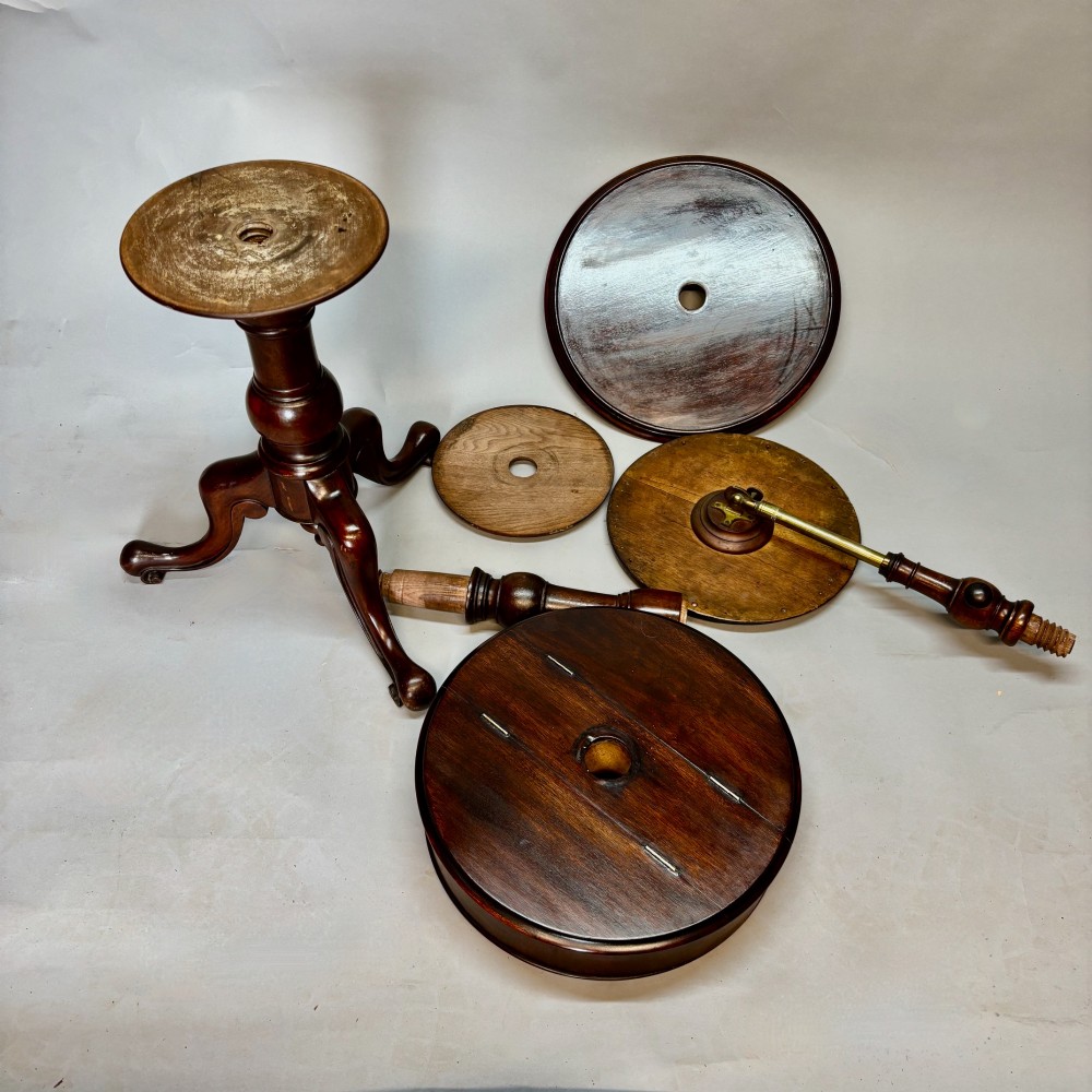A Victorian dark mahogany shaving stand featuring an adjustable circular mirror, a round tier, a hinged compartment, turned support stem, and tripod cabriole legs. View XII