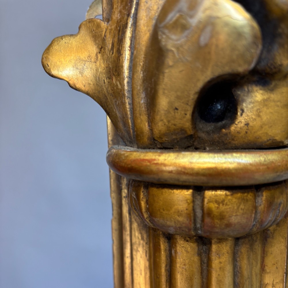 A nineteenth-century rectangular giltwood mirror featuring fluted side columns topped with carved acanthus leaf capitals. View IV