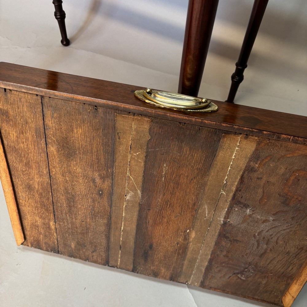 A George III mahogany side table featuring a single drawer with an oval brass handle and slender turned legs. View VII