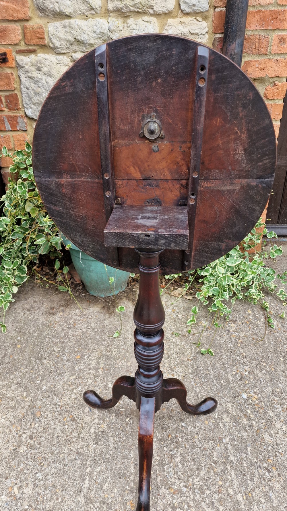 A Georgian fruitwood tilt top wine table with a circular top, turned central column, and tripod cabriole legs on pad feet. View IV