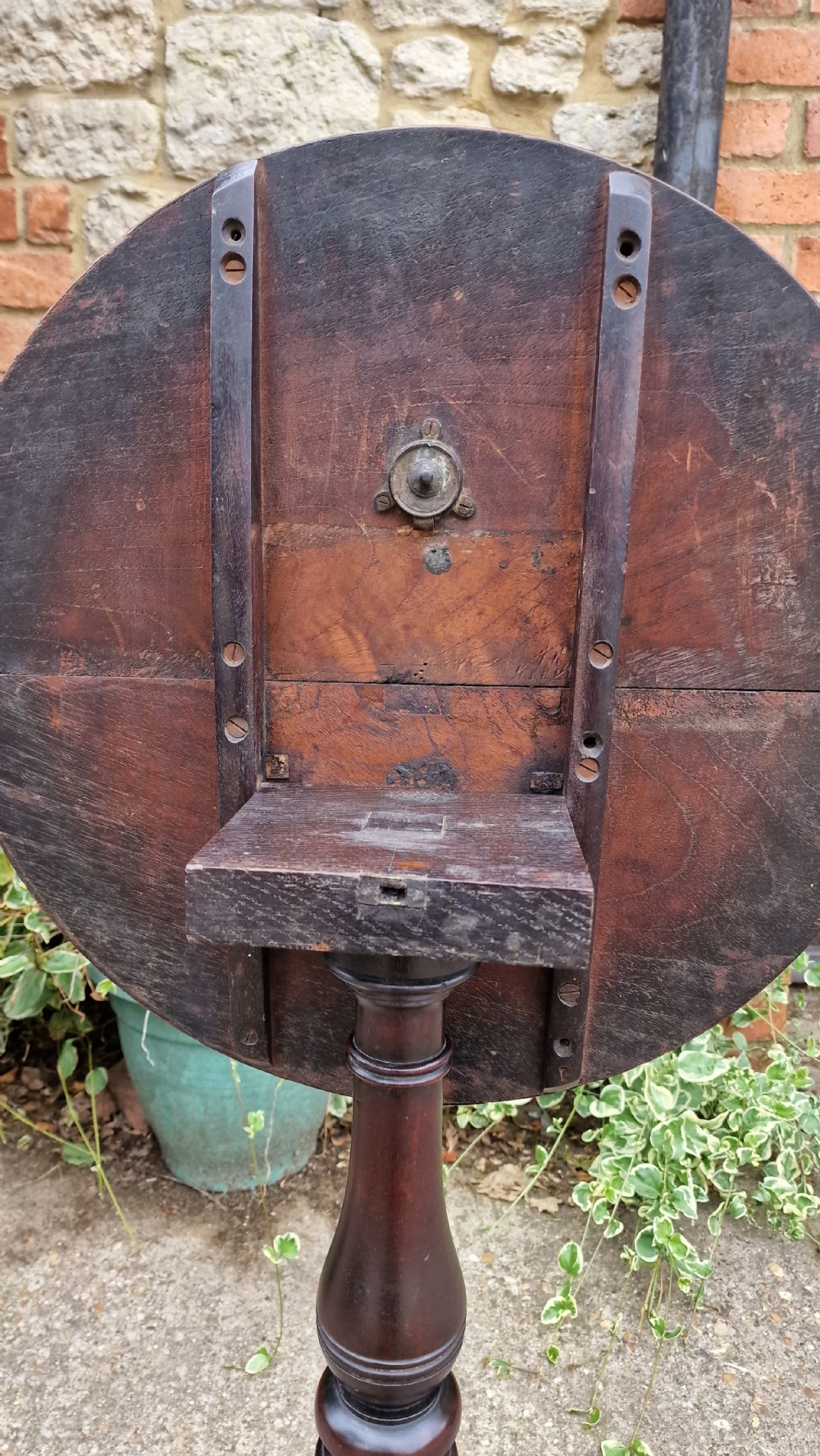 A Georgian fruitwood tilt top wine table with a circular top, turned central column, and tripod cabriole legs on pad feet. View VI