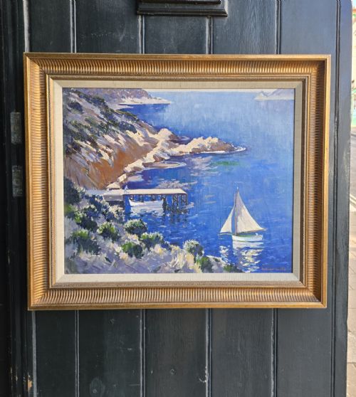 fig 1. An impressionist oil painting depicting a bright blue coastal bay with rocky cliffs, a wooden jetty, and a sailboat.