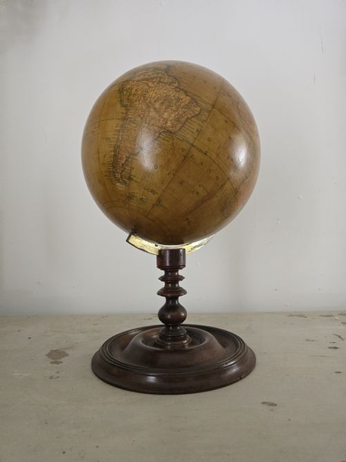 fig 1. A Victorian terrestrial table globe mounted on a turned mahogany pedestal base with a brass semi-meridian ring.