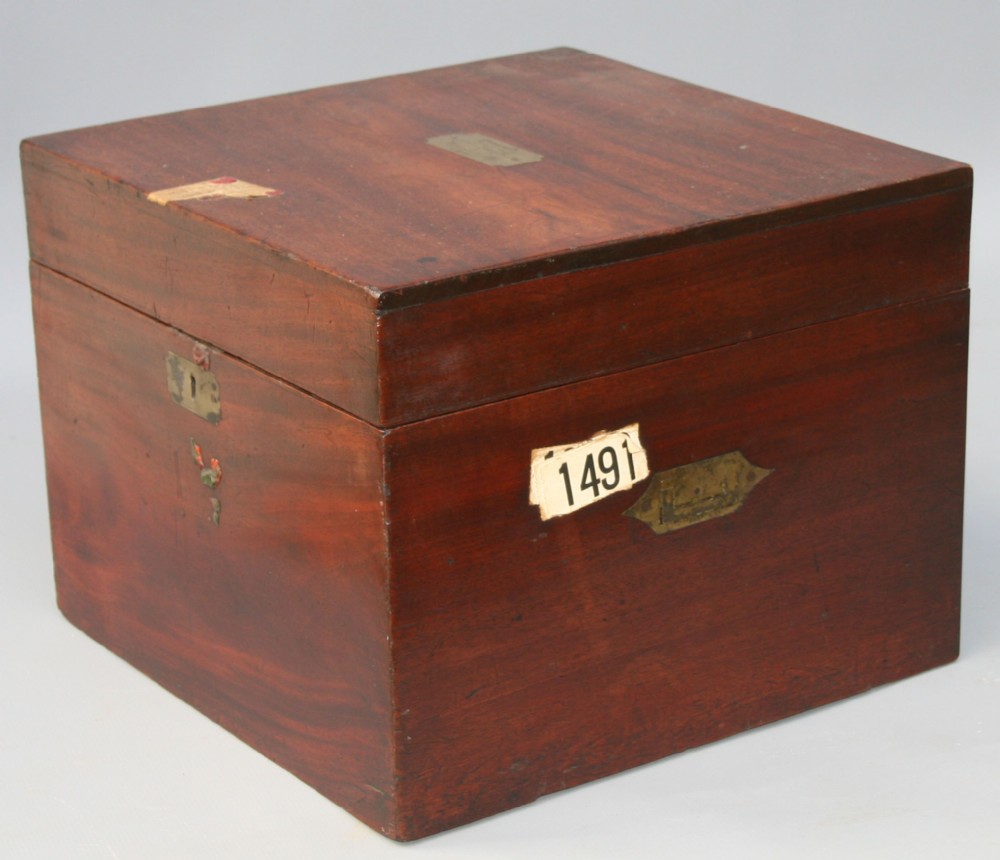 A rectangular George IV mahogany silver chest featuring a hinged lid and brass escutcheon.