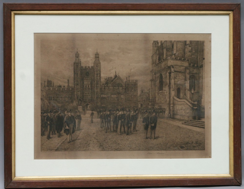 A framed sepia engraving depicting figures standing in front of historic stone architecture at Eton College, presented within a dark wooden frame with a cream mount.