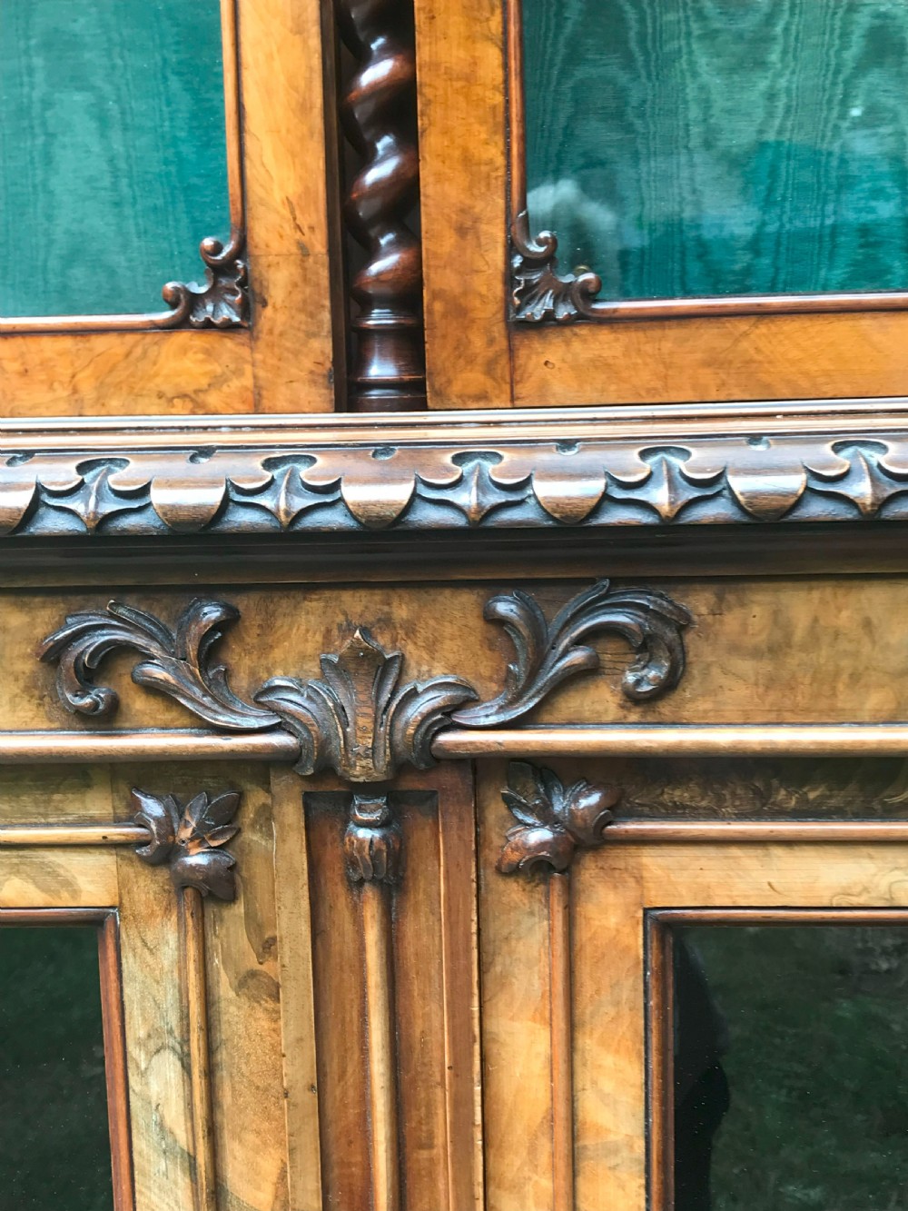 A large two-tier Victorian glazed bookcase crafted in figured walnut with spiral barley twist columns and carved mouldings. View II