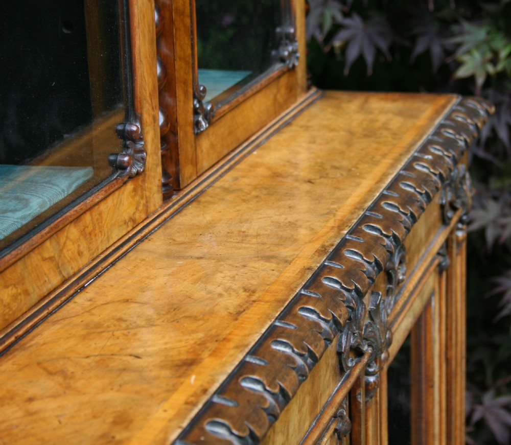 A large two-tier Victorian glazed bookcase crafted in figured walnut with spiral barley twist columns and carved mouldings. View III