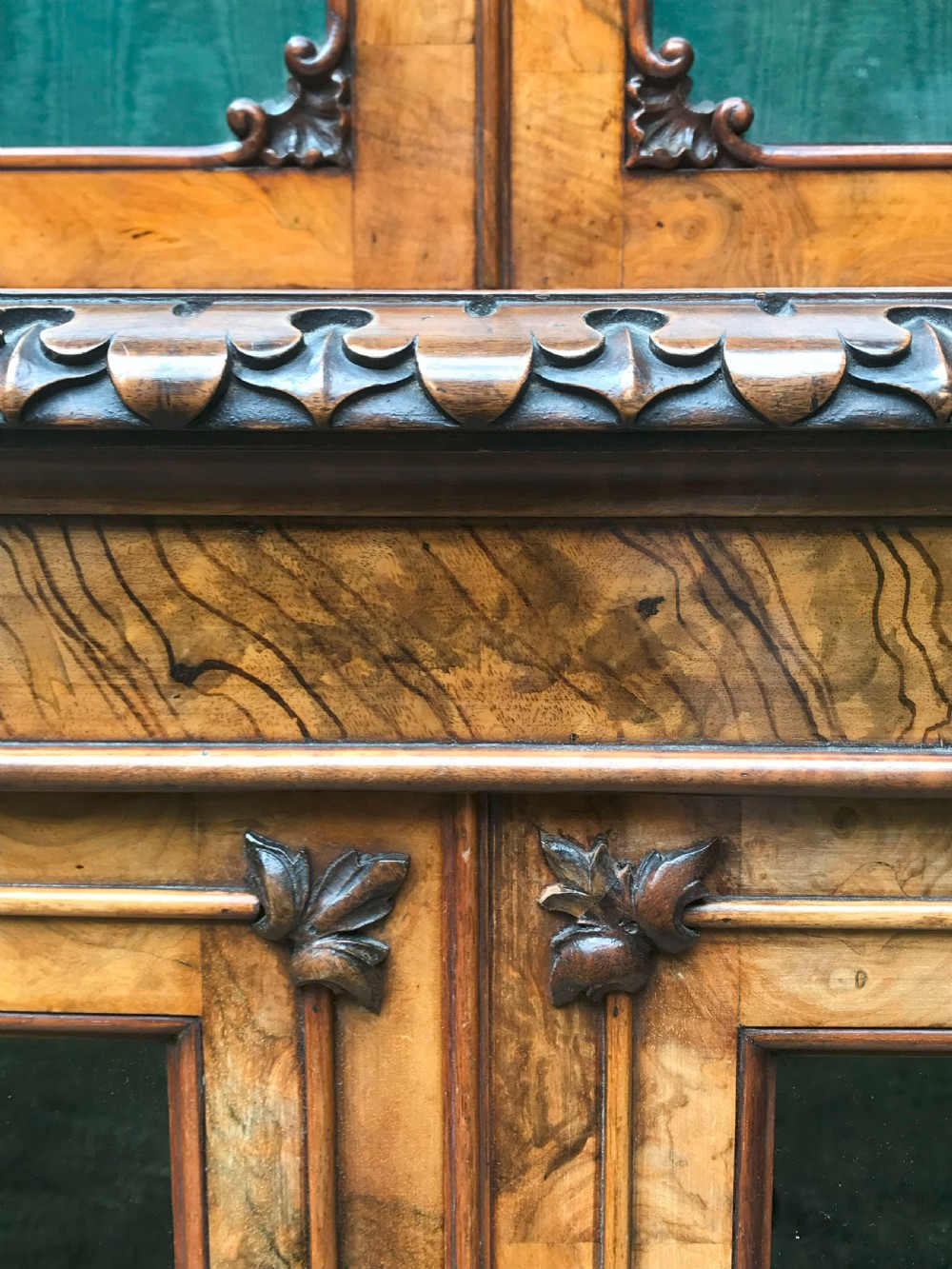 A large two-tier Victorian glazed bookcase crafted in figured walnut with spiral barley twist columns and carved mouldings. View IX