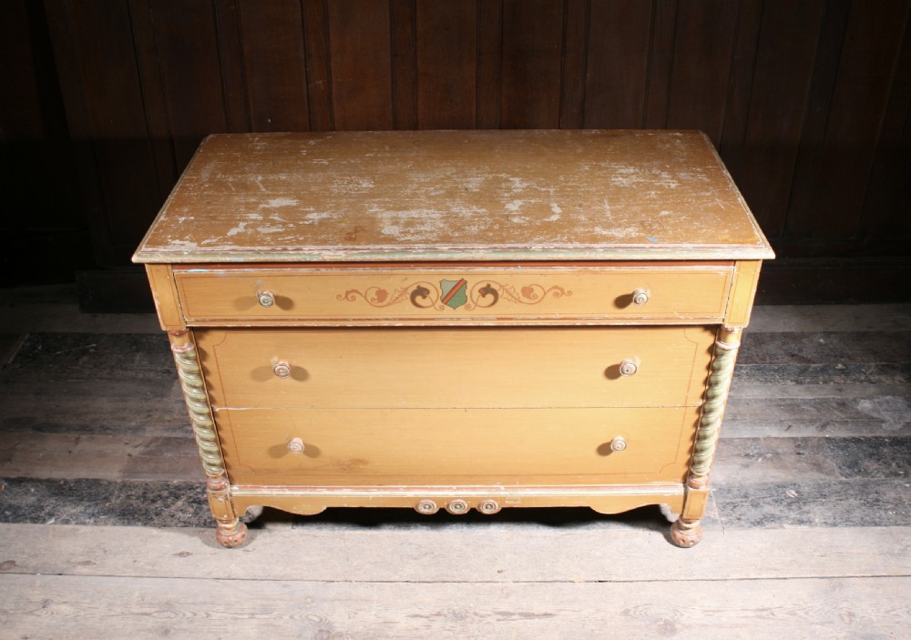 A three-drawer pine chest featuring an original yellow painted finish, rope-twist side columns, hand-painted scrollwork, and a shaped lower apron. View III
