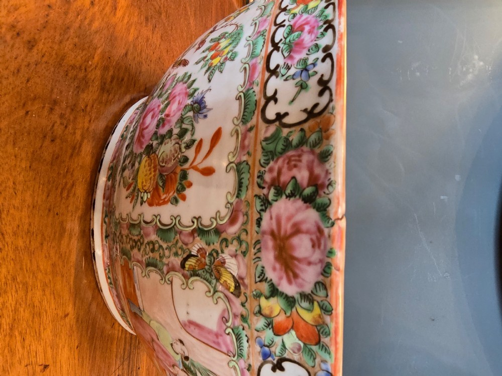 A large deep porcelain punch bowl decorated with hand-painted Chinese Famille Rose enamel motifs, featuring figures, flora, birds, and butterflies within reserves. View VII