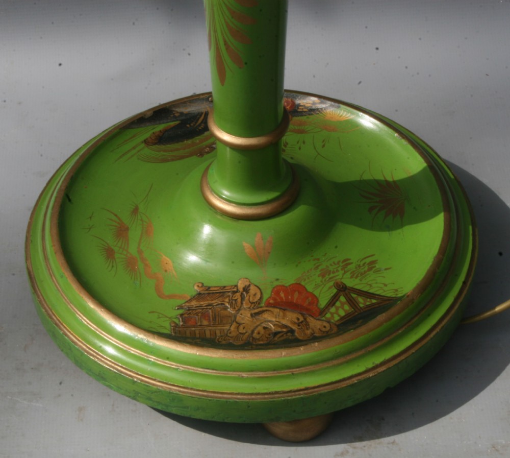 A tall green turned wooden standard lamp decorated with hand-painted gilt Chinoiserie motifs on a circular base. View V