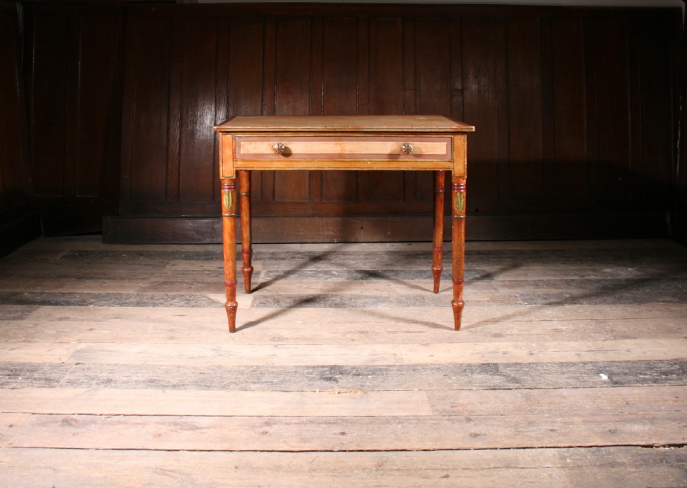 A late Georgian painted pine side table featuring a single drawer with two round knobs and slender turned legs decorated with painted details.