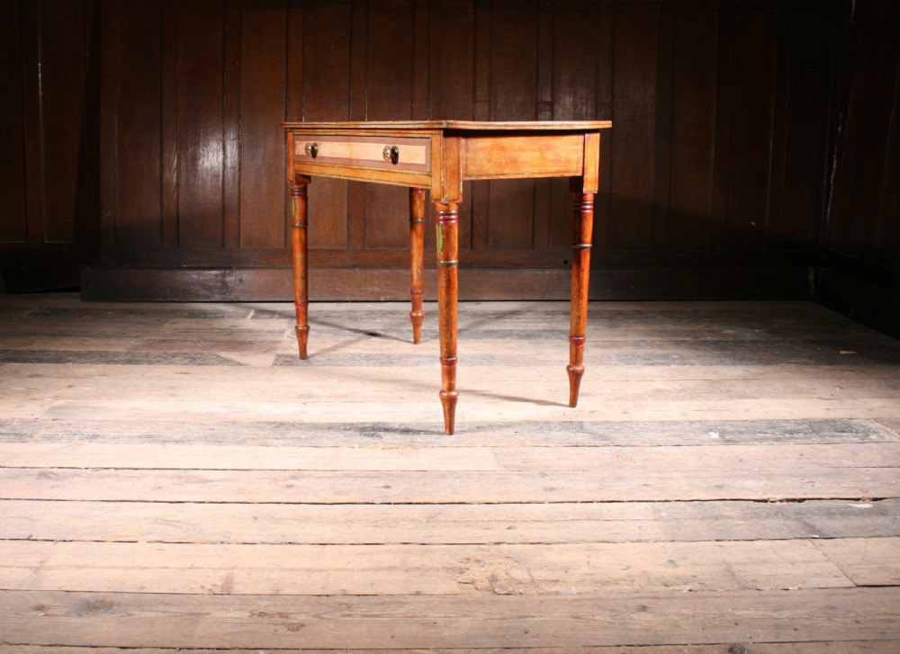 A late Georgian painted pine side table featuring a single drawer with two round knobs and slender turned legs decorated with painted details. View II