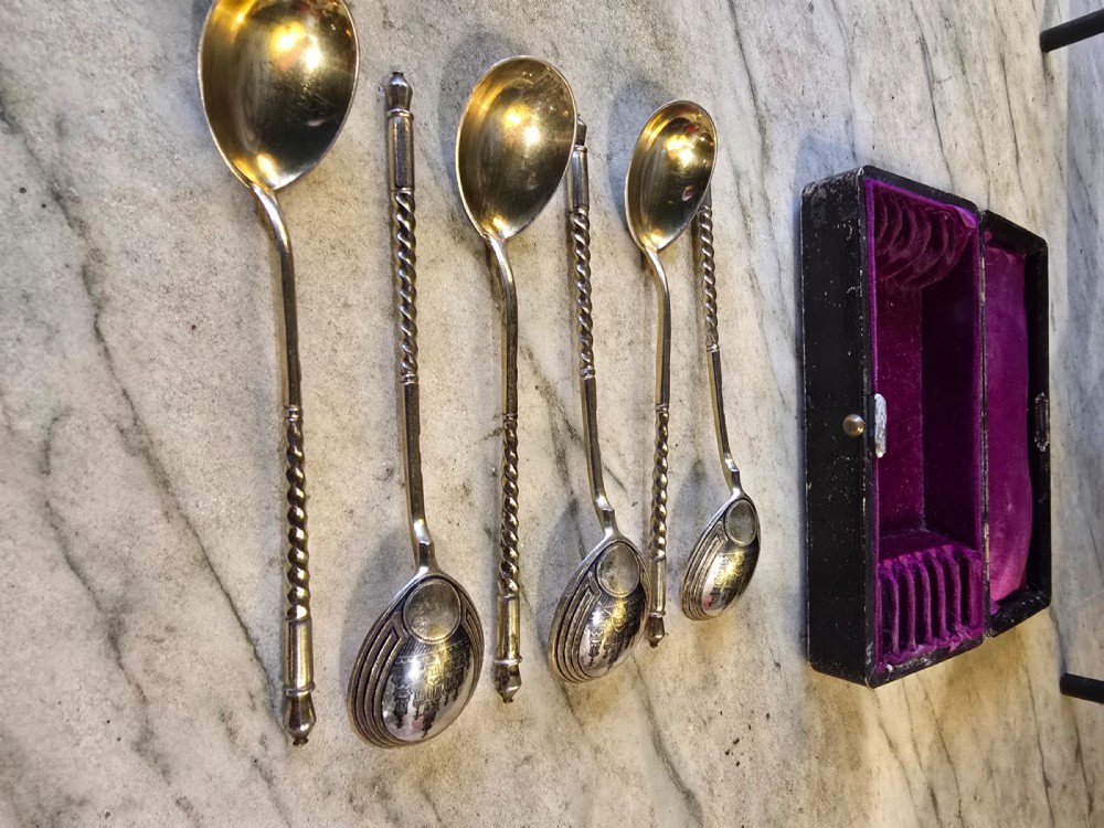 A set of six 1877 Russian niello silver spoons with twisted stems housed in a fitted black display box lined with purple velvet. View II