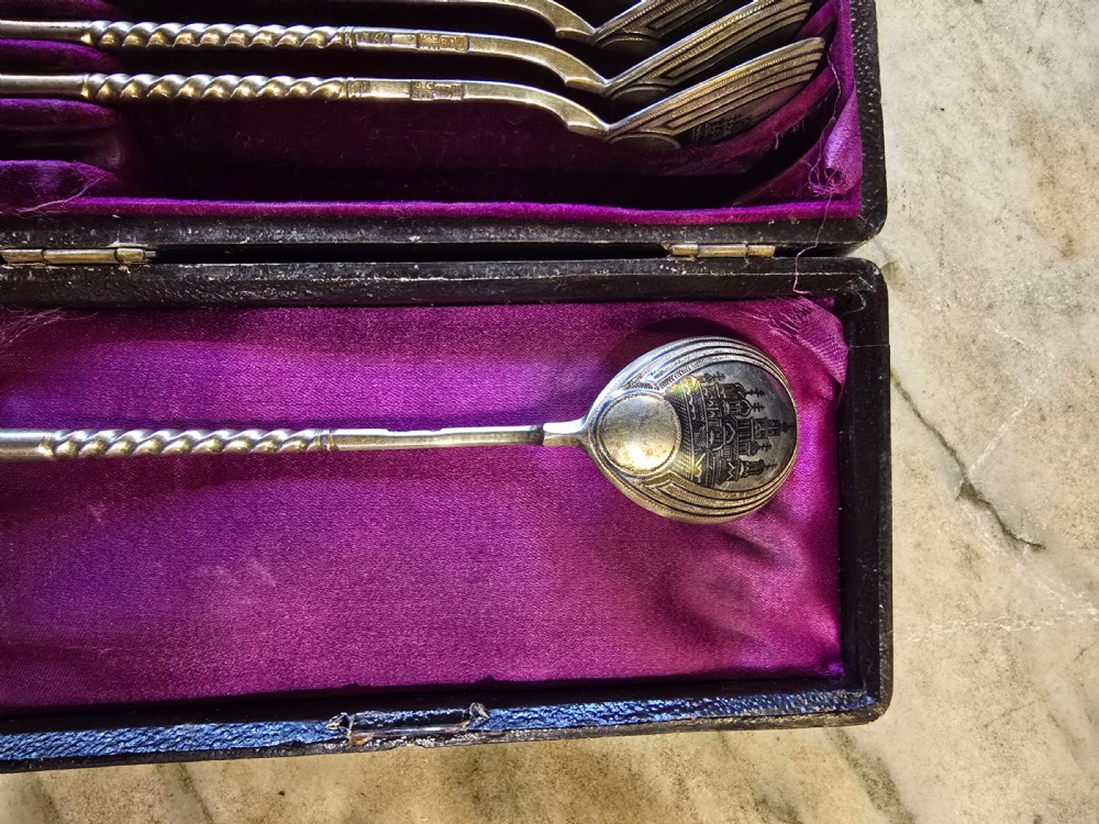 A set of six 1877 Russian niello silver spoons with twisted stems housed in a fitted black display box lined with purple velvet. View III