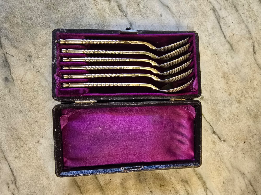A set of six 1877 Russian niello silver spoons with twisted stems housed in a fitted black display box lined with purple velvet. View V