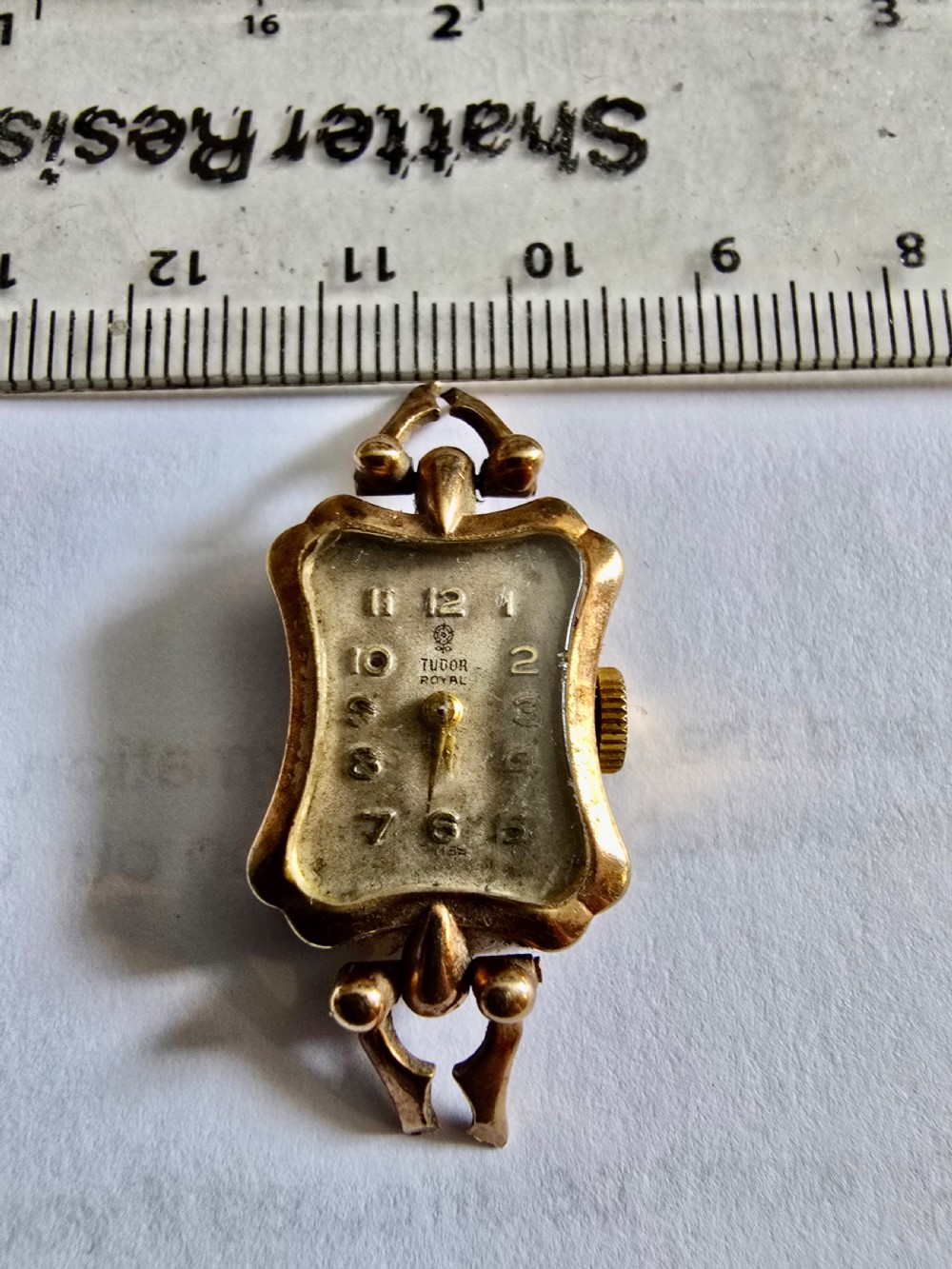 A vintage 9ct yellow gold Tudor Royal ladies cocktail wristwatch head featuring a shaped case, decorative lugs, and Arabic numerals on the dial. View VI