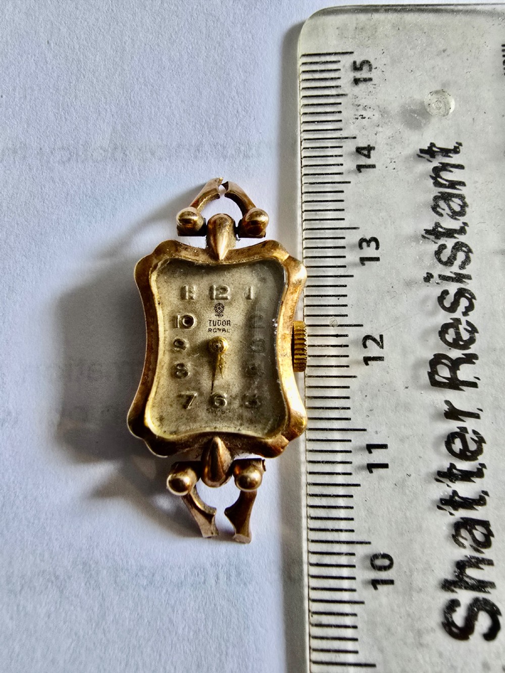 A vintage 9ct yellow gold Tudor Royal ladies cocktail wristwatch head featuring a shaped case, decorative lugs, and Arabic numerals on the dial. View VII
