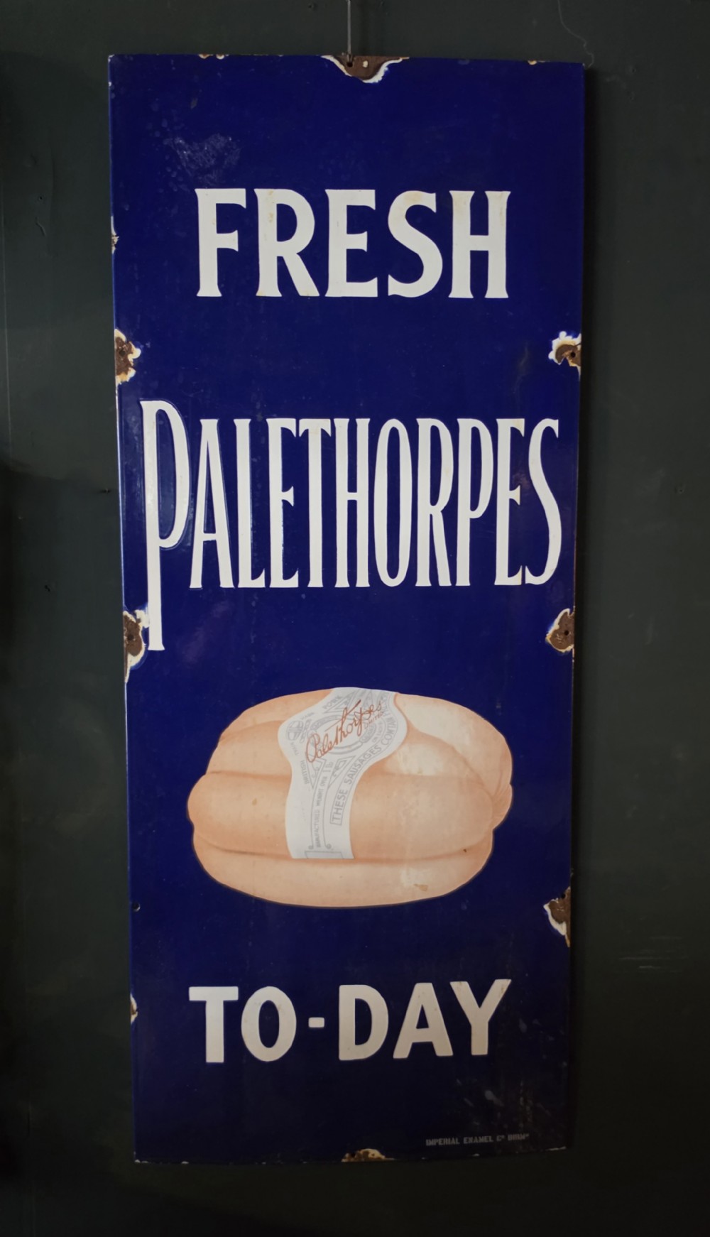 A tall vertical cobalt blue vitreous enamel sign featuring white block lettering for Palethorpes sausages and a pictorial central graphic.