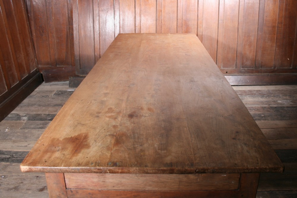 A large 19th-century antique elm farmhouse dining table with a solid wood plank top and straight tapered legs. View II