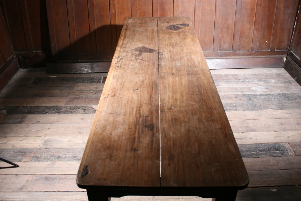 A long antique poplar farmhouse dining table featuring a twin-plank top supported by four turned wooden legs. View III