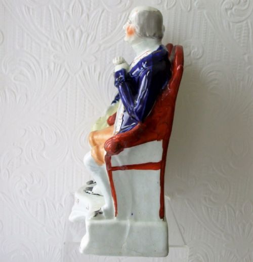 fig 1. A Victorian Staffordshire earthenware portrait figure depicting a seated elderly couple in cobalt blue jackets with the inscription John Anderson My Jo on the base.