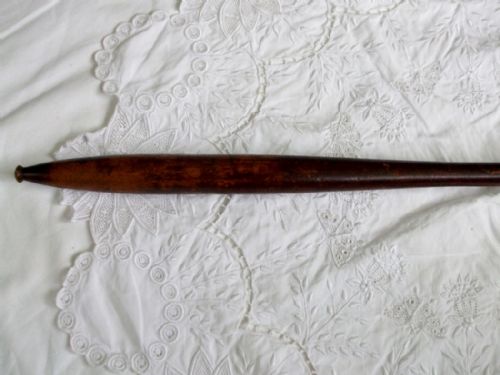 fig 1. An antique Victorian wooden alms dish featuring a long turned handle and an octagonal box lined with green felt.