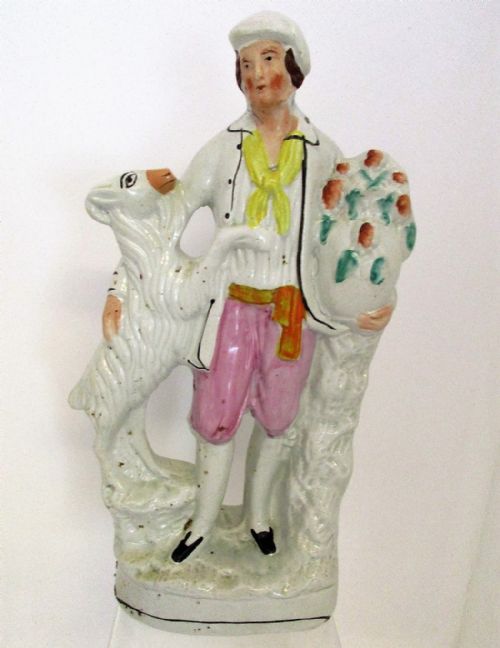 fig 1. A pair of antique Victorian Staffordshire earthenware figures depicting a male and female goatherd with goats and baskets of flowers.