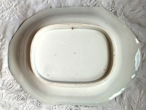 fig 1. An octagonal cream earthenware dish featuring a central transfer-printed portrait of Dr Livingstone framed by flowers, flags, and a purple rim motif.