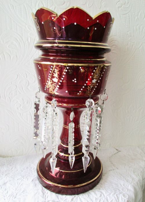 fig 1. A pair of deep ruby red glass Victorian lustres featuring scalloped upper rims, hand-painted gold foliage, and suspended clear cut-crystal prisms.
