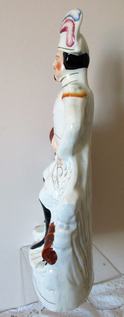 fig 1. An antique Victorian Staffordshire earthenware portrait figure depicting Emperor Napoleon III in uniform seated beside a cannon.