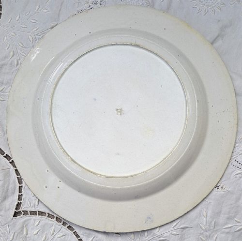 fig 1. A circular Georgian blue and white transferware plate featuring a pastoral scene with cattle and a grand house surrounded by a detailed botanical border.