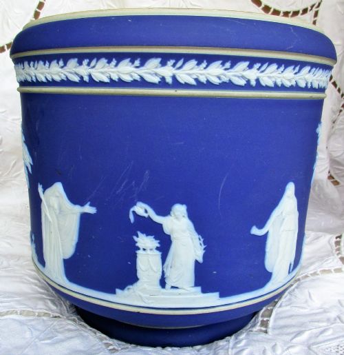 fig 1. A deep cobalt blue Victorian jasperware ceramic jardiniere decorated with white classical relief figures, trees, and a foliate rim border.