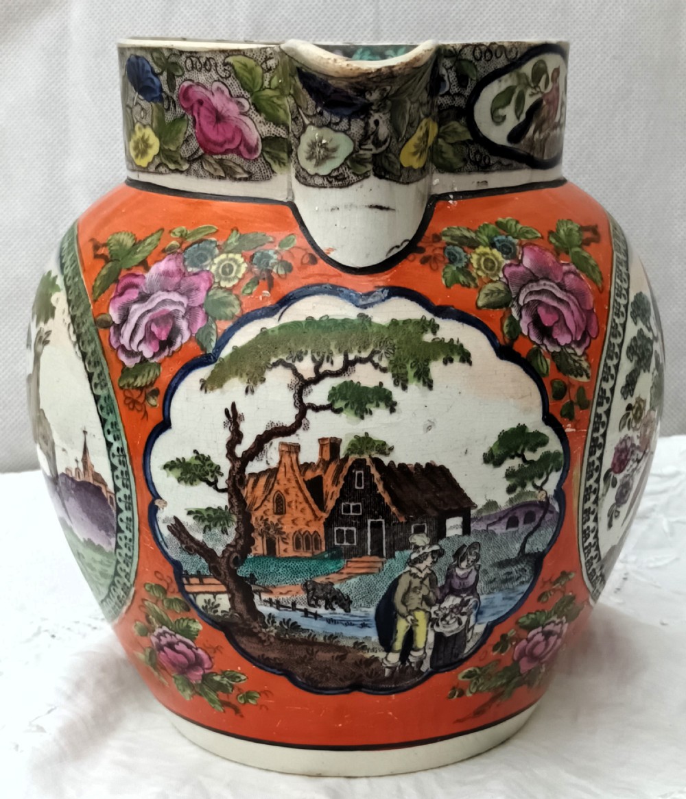 An antique Georgian pearlware Dutch jug featuring a bright orange ground and decorative oval medallions depicting hand-painted polychrome birds and foliage. View V