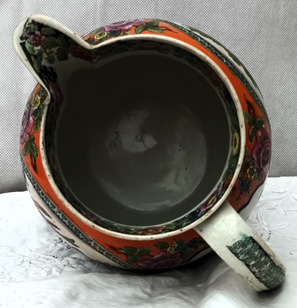 An antique Georgian pearlware Dutch jug featuring a bright orange ground and decorative oval medallions depicting hand-painted polychrome birds and foliage. View VIII