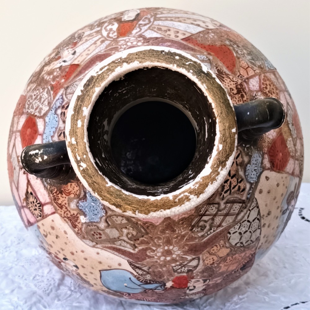 A Japanese Meiji period Satsuma earthenware vase decorated with hand-painted figures, bamboo-shaped handles, and gold gilding on a crackle glaze background. View VII