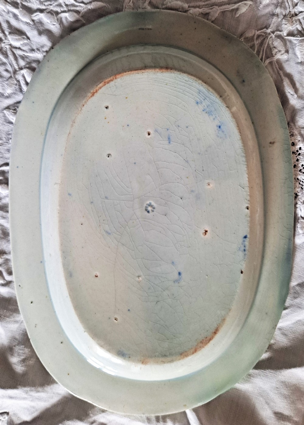 An oval Georgian earthenware serving dish featuring a cobalt blue transferware pattern of classical ruins and surrounding landscape. View II