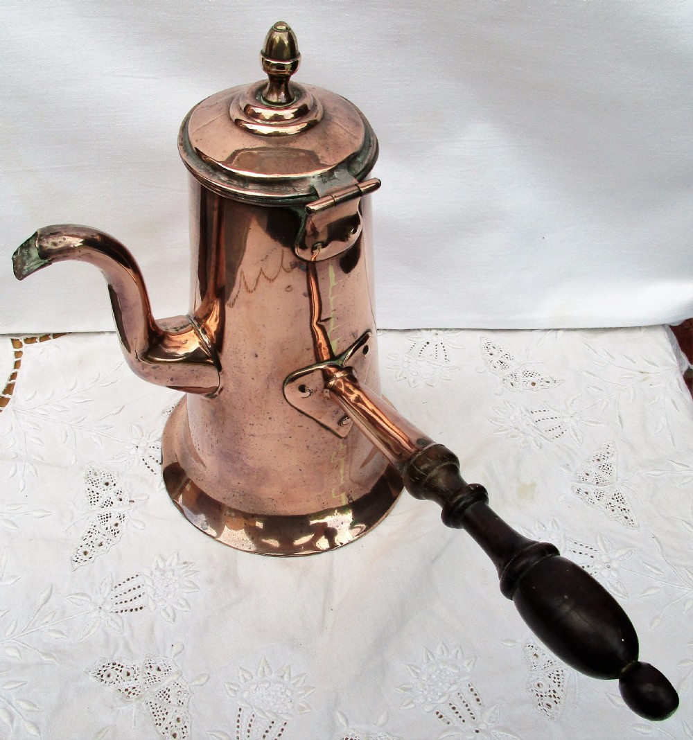 An antique Georgian copper coffee pot featuring a curved goose-neck spout, a hinged lid with a brass finial, and a turned dark wood side handle. View VI
